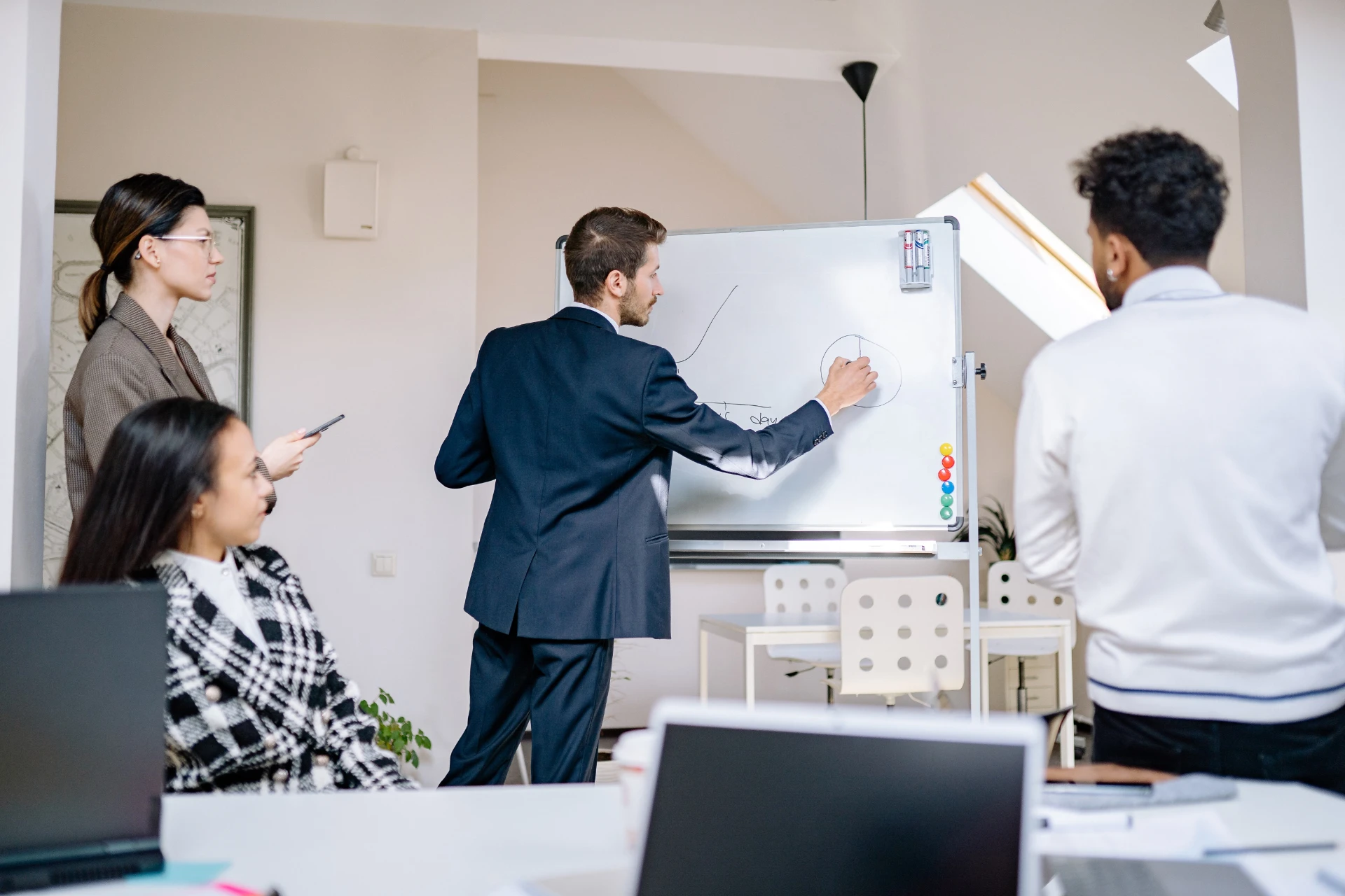 Founders working through an idea together at a whiteboard